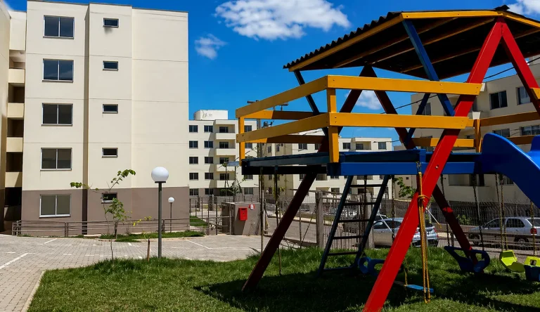 Conjunto habitacional com prédios residenciais e playground infantil em área comum no Residencial Recanto das Águas